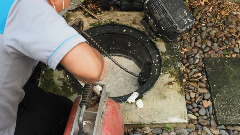 Drain Cleaning Plumber Repairing Clogged Grease Trap With Auger Machine Maintenance Sewage System Grease Trap By Professional Plumber Using Auger Snake Fix Unclog Drain